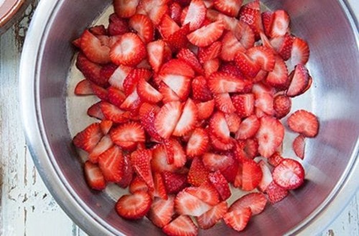 Strawberries cut into quarters for Chilean strawberries and cream
