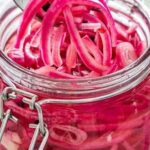 Jar of bright pink quick pickled red onions