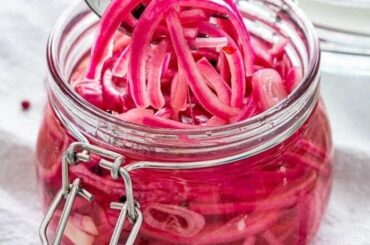 Jar of bright pink quick pickled red onions