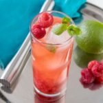 Raspberry mojito with fresh mint, lime, and crushed raspberries over ice