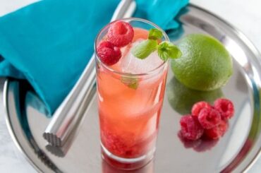 Raspberry mojito with fresh mint, lime, and crushed raspberries over ice