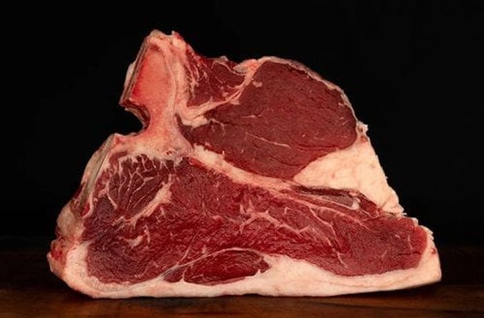 Raw bone in entrecôte steak ready for the grill