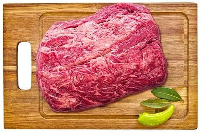 Raw Chilean ribeye roast with its fat seam, ready for lomo vetado al horno