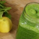 Green spinach and lemon smoothie in a glass