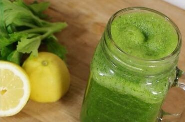 Green spinach and lemon smoothie in a glass