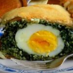 Spinach pascualina, a savory pie with spinach, cheese, and whole hard boiled eggs