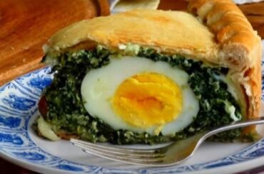 Spinach pascualina, a savory pie with spinach, cheese, and whole hard boiled eggs