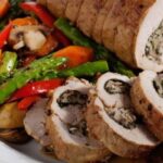 Oven baked pork loin stuffed with spinach and mushrooms, sliced