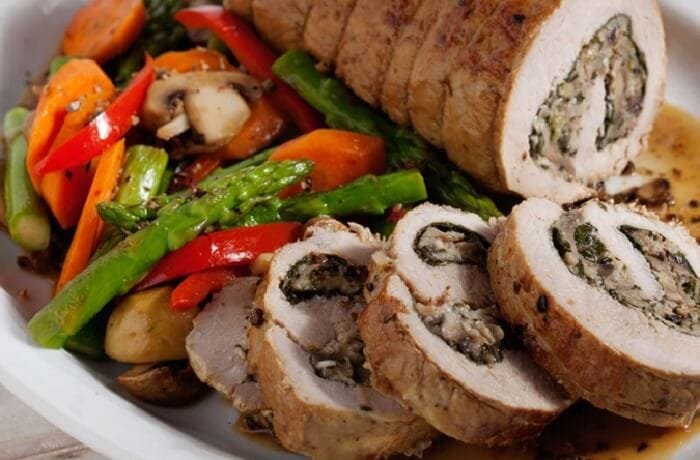 Oven baked pork loin stuffed with spinach and mushrooms, sliced
