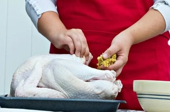 Stuffing the Christmas turkey with couscous, raisins, almonds, and olives