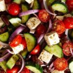 Traditional Greek salad with feta cheese, cherry tomatoes, cucumber, and black olives