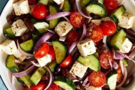 Traditional Greek salad with feta cheese, cherry tomatoes, cucumber, and black olives