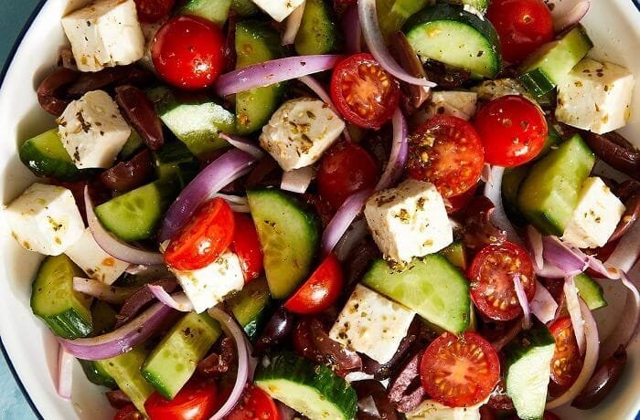 Traditional Greek salad with feta cheese, cherry tomatoes, cucumber, and black olives