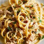 Tagliatelle with tuna and cream sauce garnished with parsley and chives