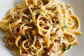 Tagliatelle with tuna and cream sauce garnished with parsley and chives
